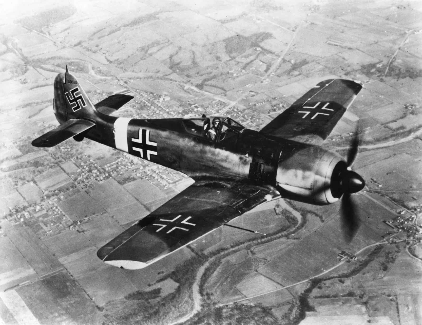 World War II German Focke-Wulf Fw 190 fighter aircraft in flight over farmland