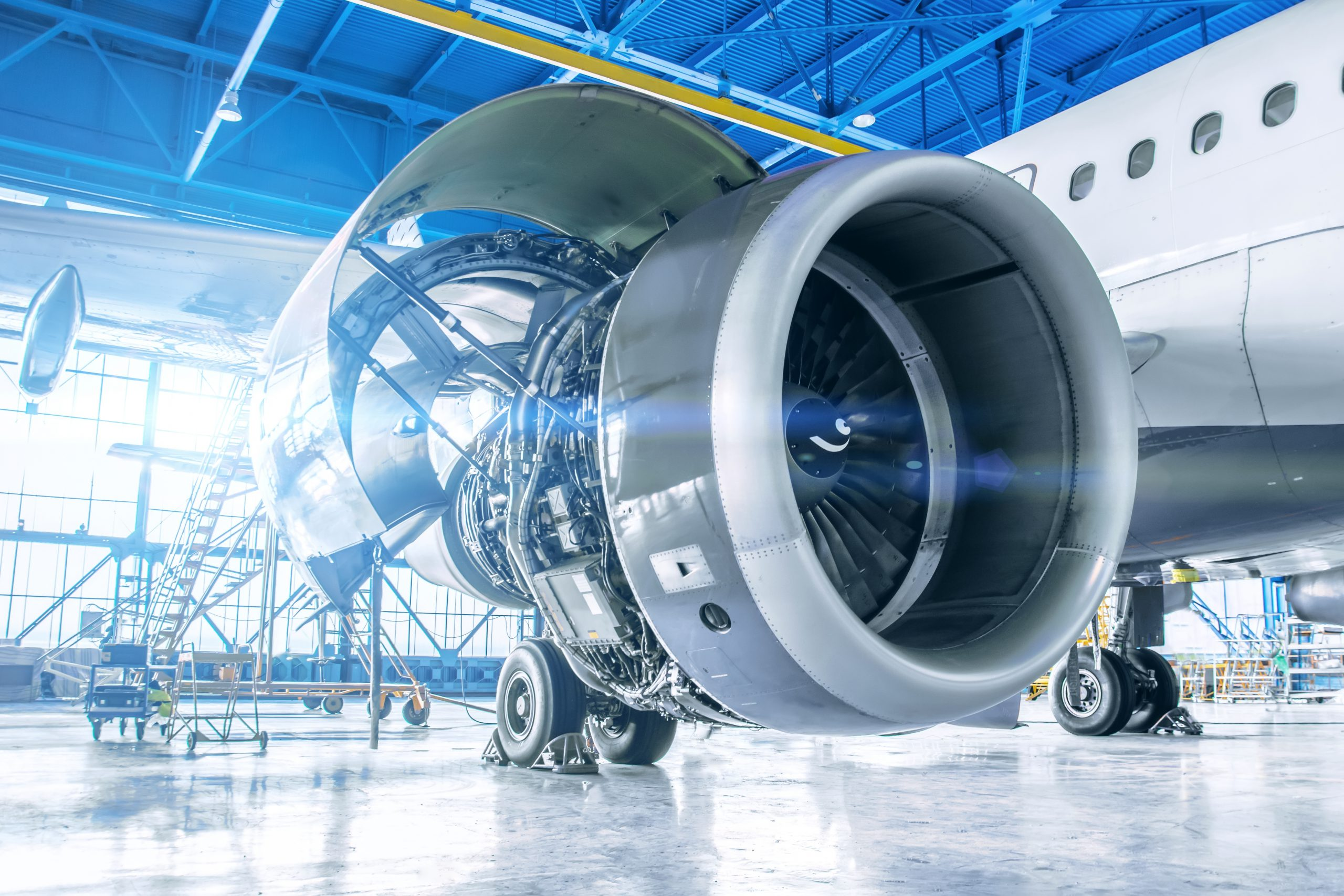 Aircraft jet engine undergoing maintenance in a hangar