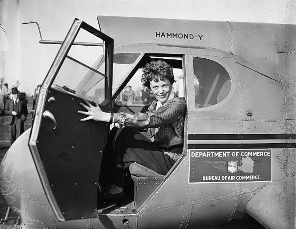 Amelia Earhart seated in the cockpit of a Department of Commerce Bureau of Air Commerce Hammond-Y aircraft