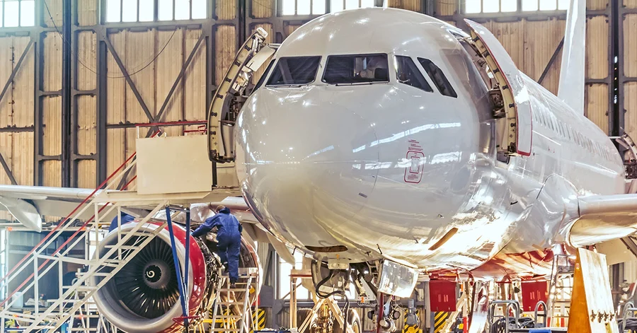 Aircraft undergoing MRO maintenance service inside a hangar